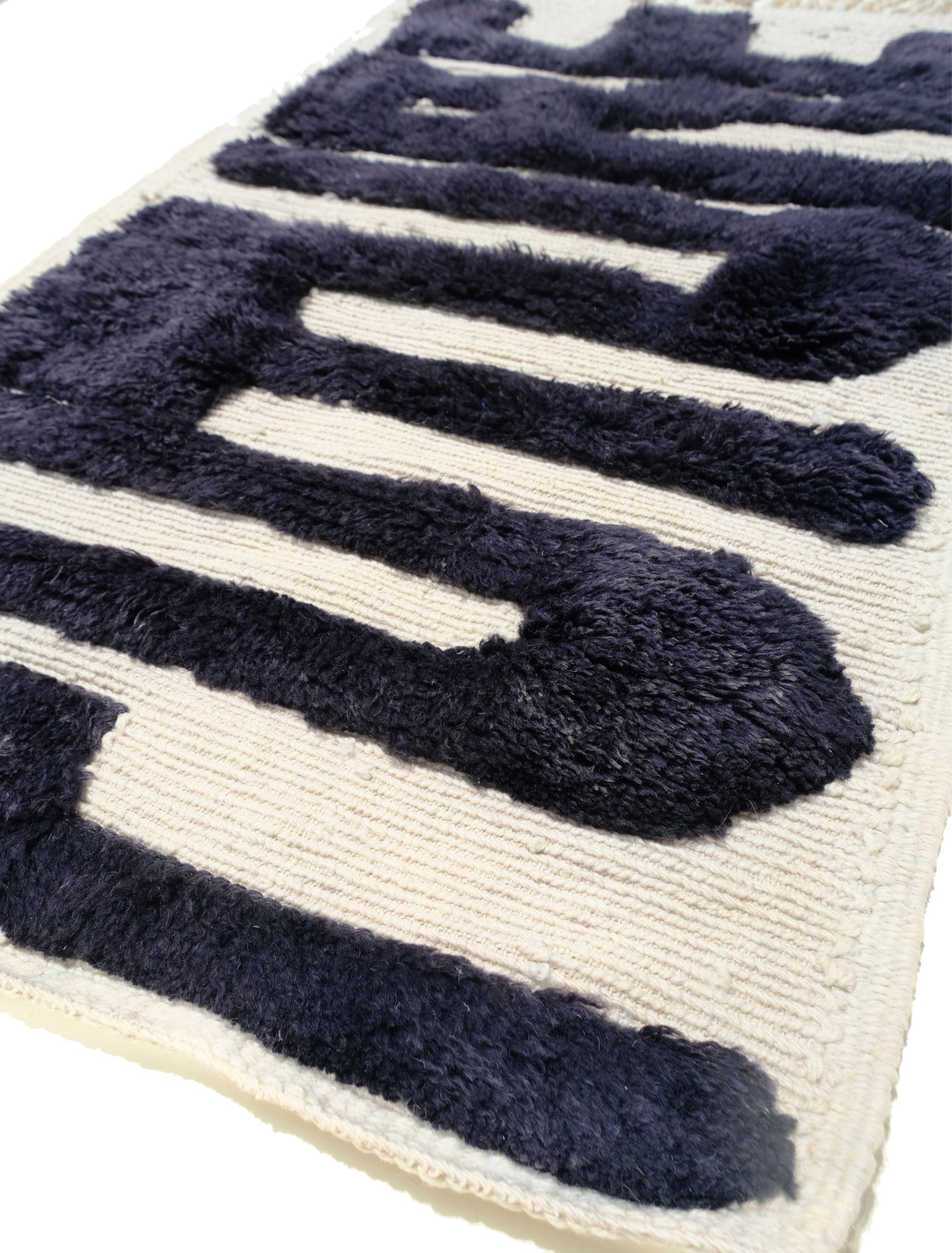 Elevate your space with the captivating "Ivory Noir Elegance Rug." Featuring embossed 'Future' letters in bold black yarn, this rug boasts a textured charm that adds a modern twist to classic black and white aesthetics. The result is a statement piece that seamlessly blends elegance and contemporary flair, making it an ideal addition to your home décor.