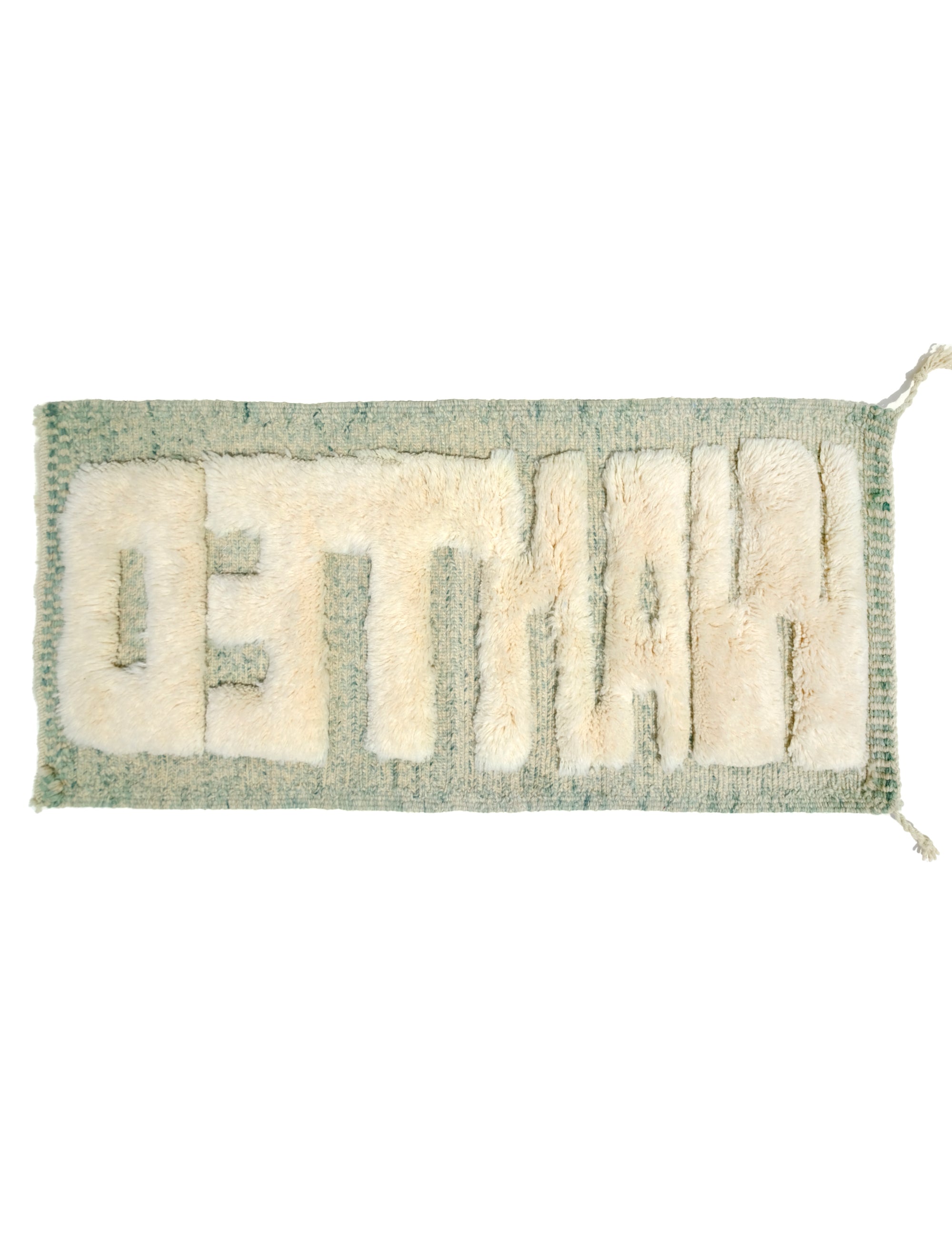 Discover the Reversible Ivory Green Whispers Rug, a truly unique and versatile piece handmade by Berber women in the Atlas Mountains. With its fuzzy 'WANTED' lettering on one side and a calming mix of pale green shades on the other, this rug adds an elegant touch to your decor while spreading a positive message. Explore the beauty of reversible design in this exceptional handmade creation.