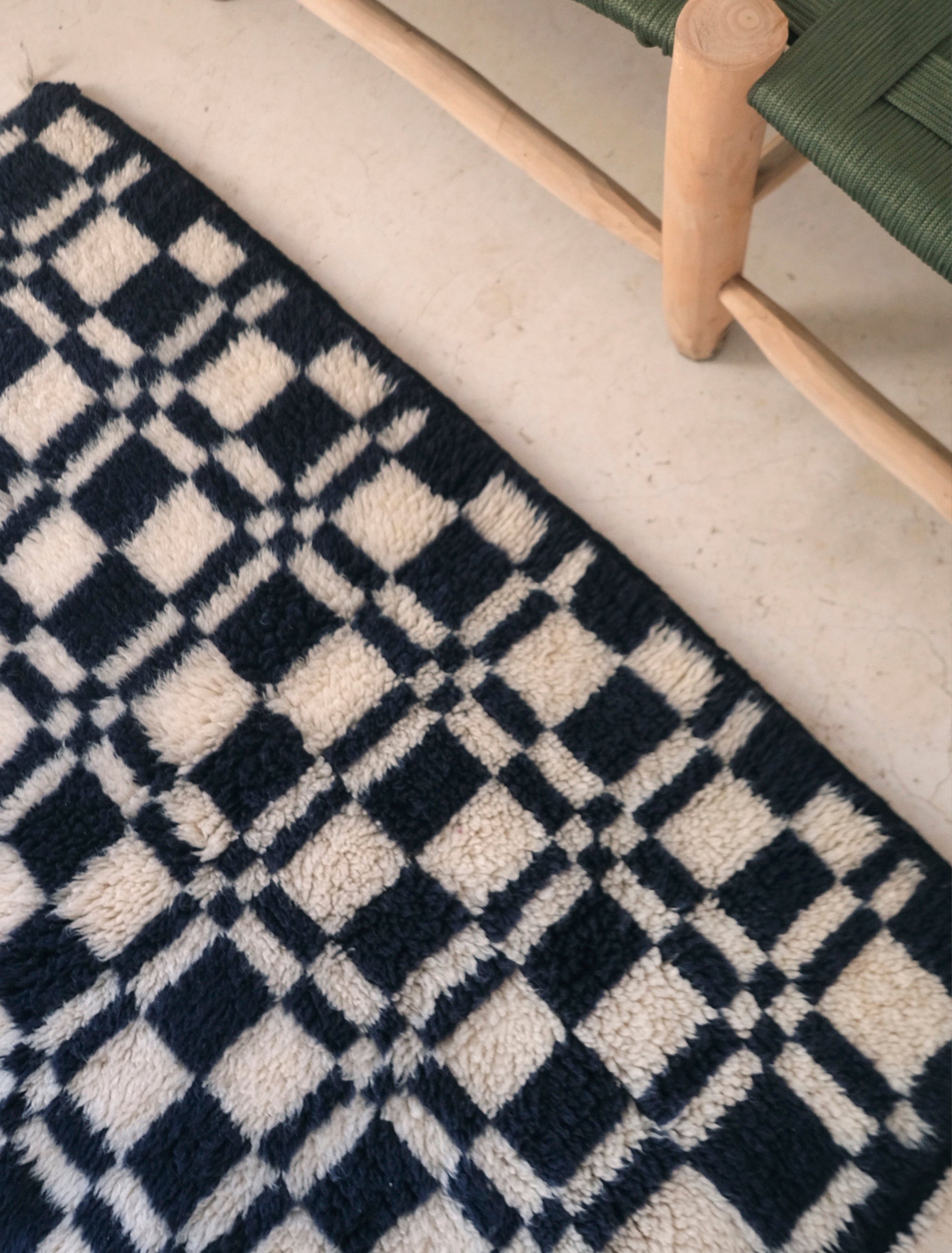Discover the 'Navy Checkmate Rug' – a timeless blend of navy, ivory, and deep crimson in a classic checkerboard pattern. Elevate your space with this elegant, handcrafted piece that adds a touch of sophistication to any room. Explore our checkerboard collection for a stylish addition to your home decor.