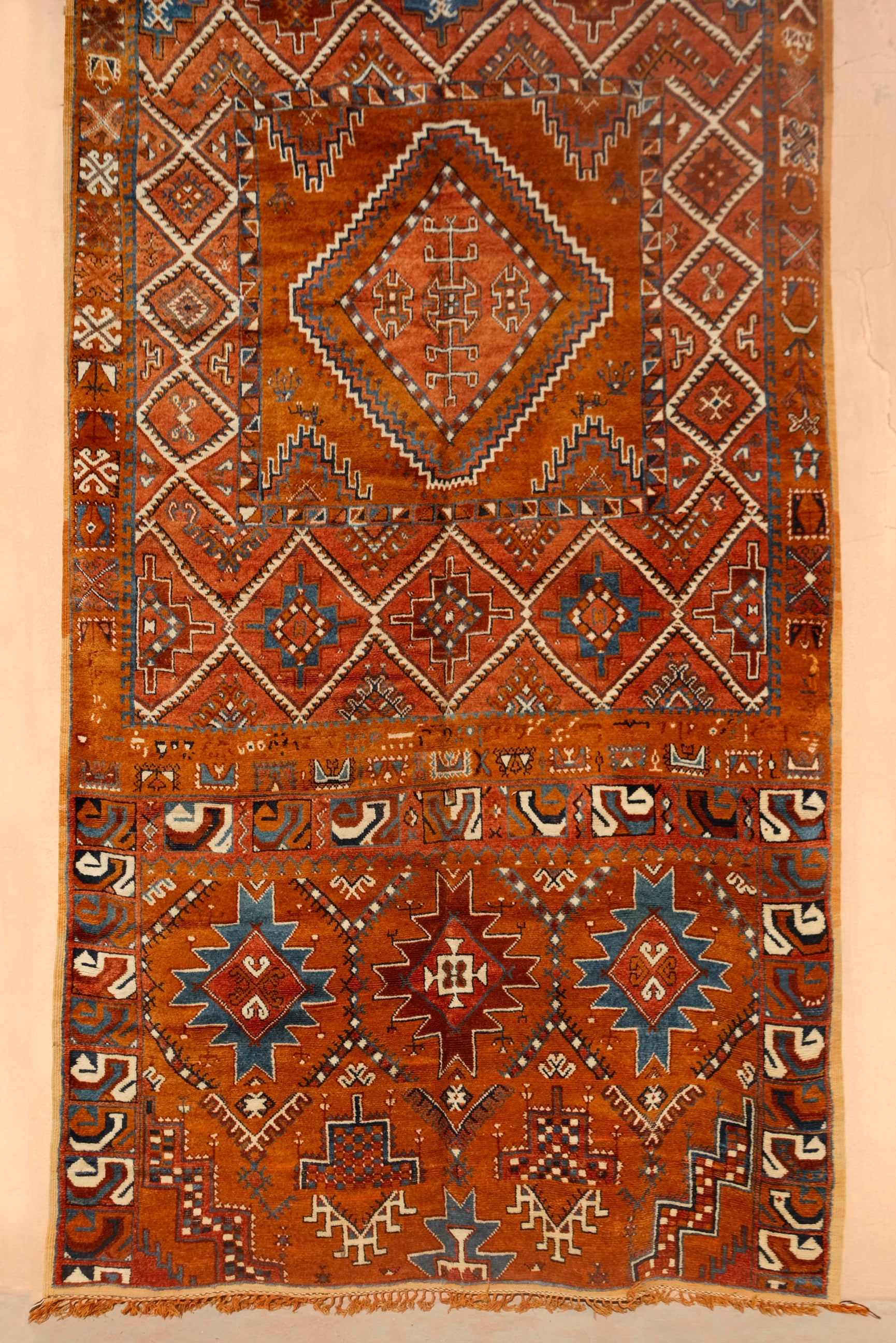  Explore unparalleled beauty with our Atlas Heritage Radiance Glawi Rug. Meticulously crafted using the highest weaving technique in the High Atlas Mountains, this museum-quality rug is a rare find. With natural dyes and a distinctive reddish-brown tone, this 50-year-old new, dead-stock piece is a unique testament to traditional craftsmanship. Limited availability.