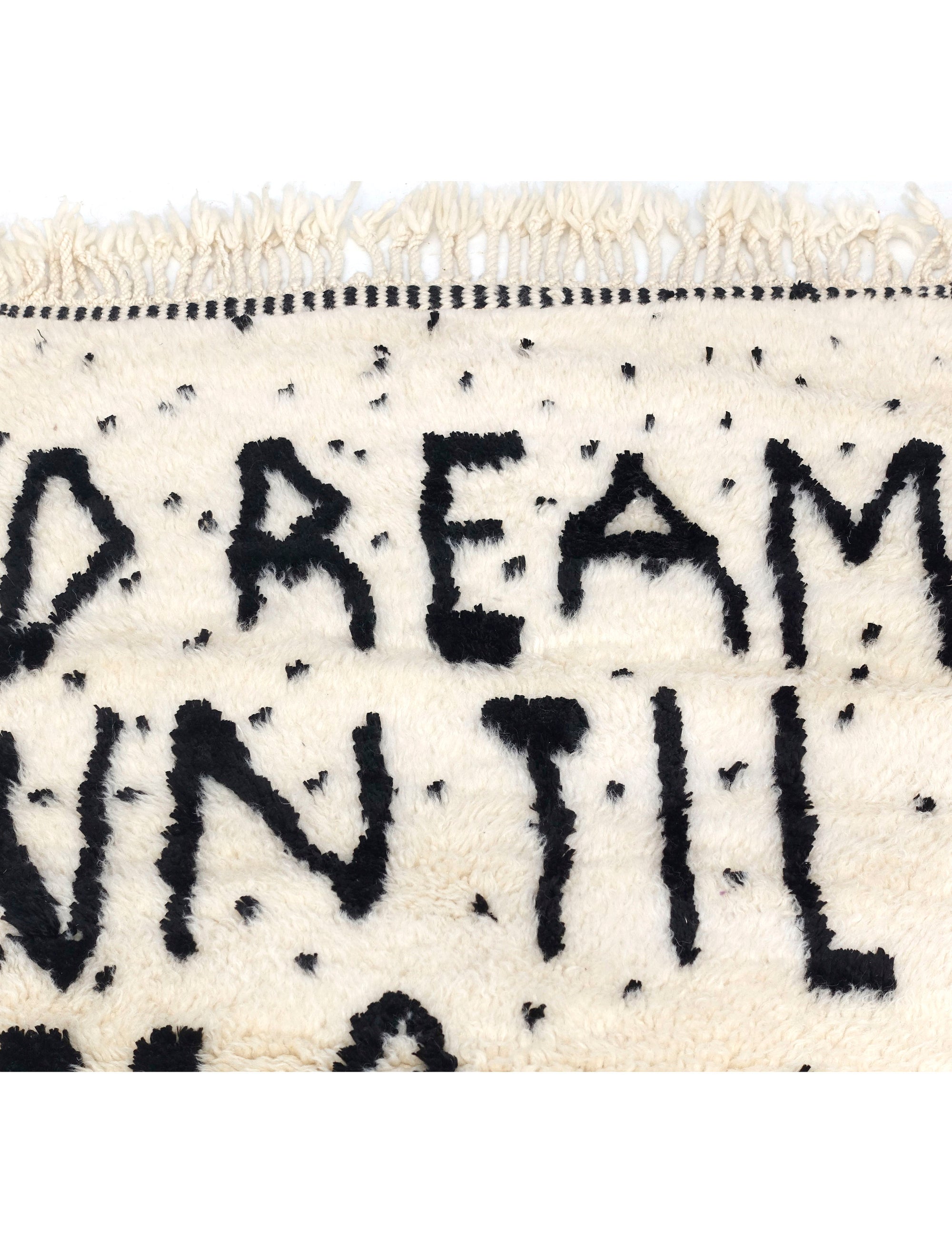 Experience the captivating allure of our Ivory Dreamscape Berber Rug, where the timeless charm of classic English script weaves a mantra of inspiration: "Dream Until It Is Your Reality." Immerse your space in this exquisite blend of classic design and motivational sentiment, transforming your home with an air of elegance and aspiration.
