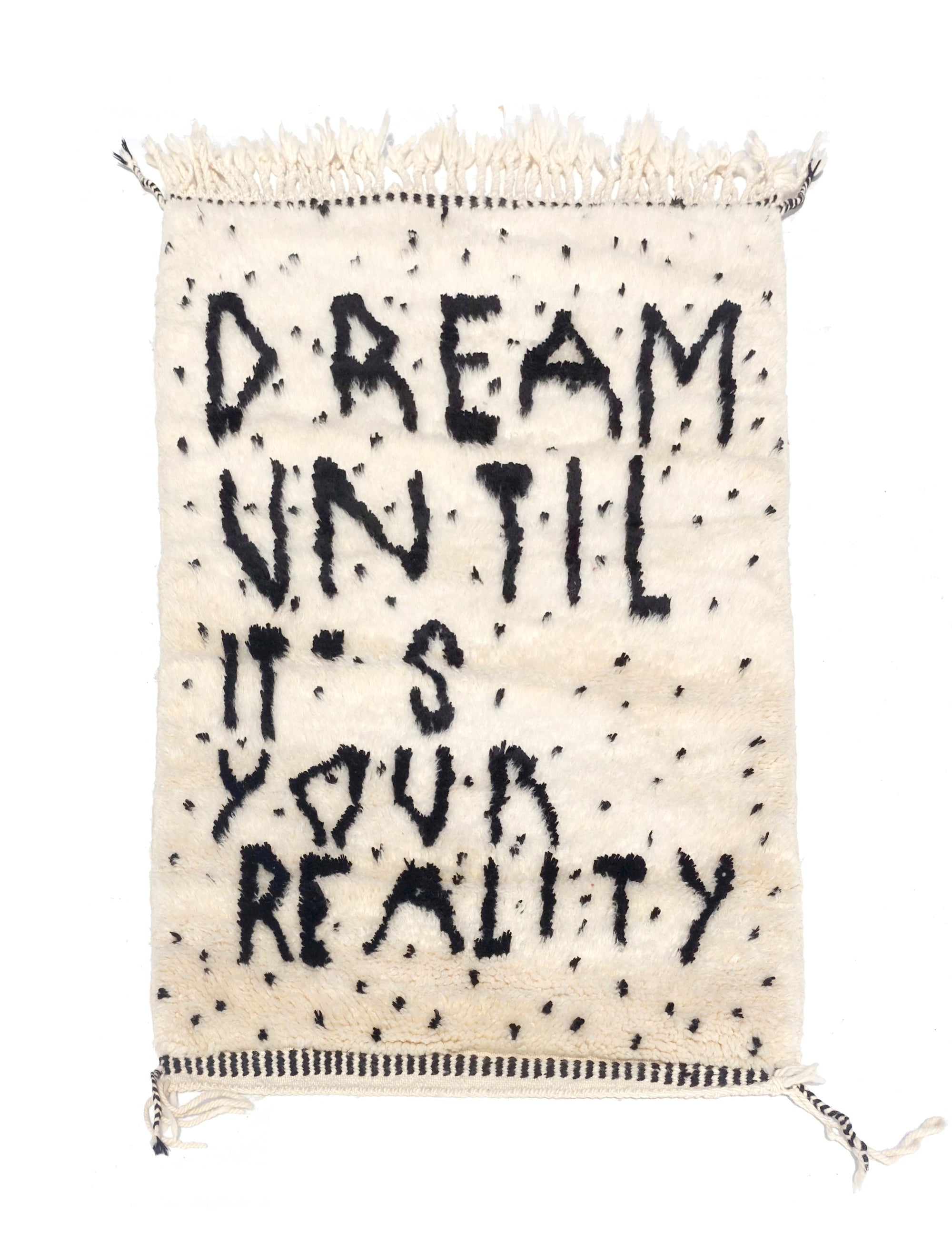 Experience the captivating allure of our Ivory Dreamscape Berber Rug, where the timeless charm of classic English script weaves a mantra of inspiration: "Dream Until It Is Your Reality." Immerse your space in this exquisite blend of classic design and motivational sentiment, transforming your home with an air of elegance and aspiration.