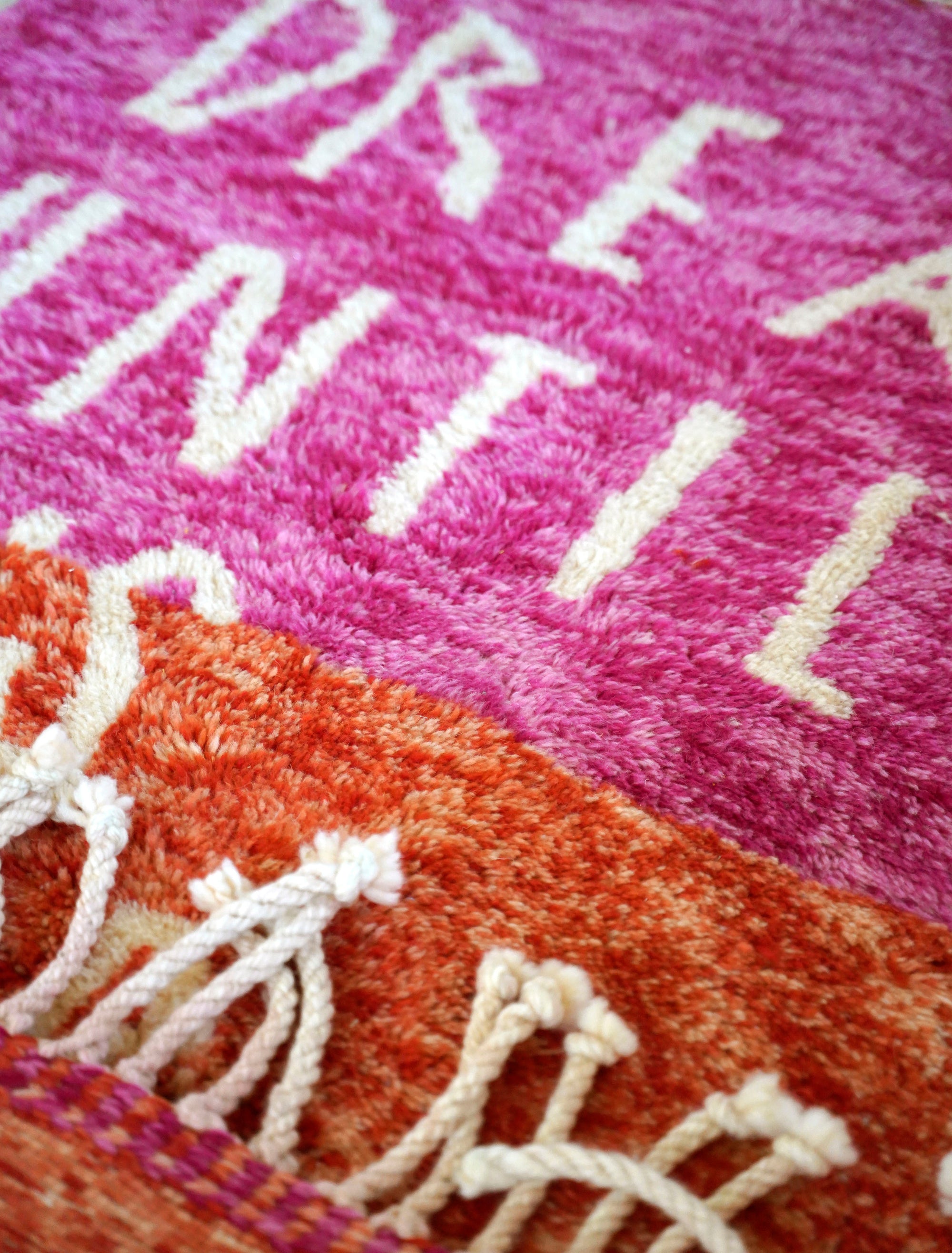 Introducing the enchanting 'Rosy Dreamscape Rug,' a delightful fusion of pink and red yarns forming a playful base, with the inspiring phrase 'Dream Until It Is Your Reality' expertly woven in white yarn. Elevate your space with this captivating blend of colors and motivational message, creating a joyful and imaginative ambiance that adds a touch of beauty and positivity to your home.