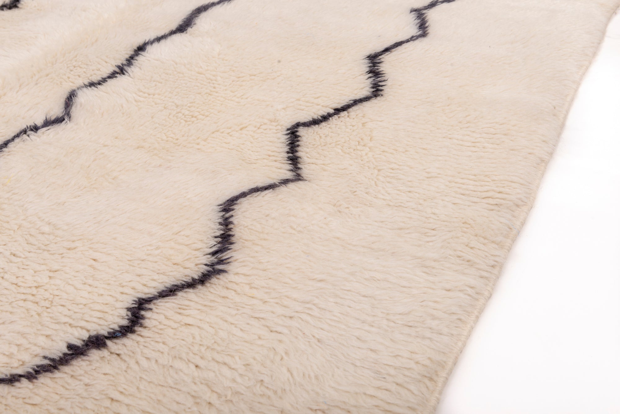Elevate your space with our 'Ivory Streamlined Monochrome Rug.' Featuring a sleek ivory base adorned with black abstract lines, this rug effortlessly combines minimalistic design with modern flair, creating a captivating addition to your decor.