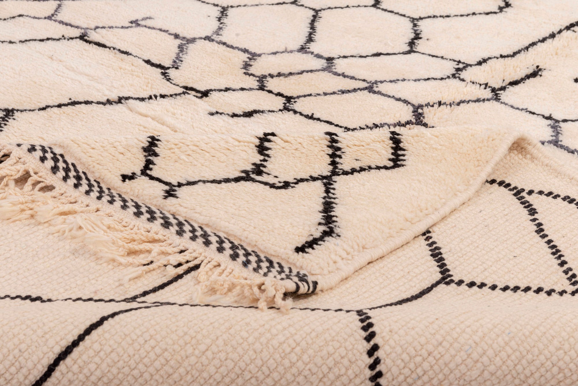 Elevate your space with our 'Ivory Infinite Net Beni Ourain Rug.' Featuring an exquisite ivory base adorned with an abstract net pattern, this rug effortlessly combines classic elegance with modern allure. Handcrafted with precision, it adds a touch of sophistication to any room. Discover the timeless charm of this one-of-a-kind rug today.