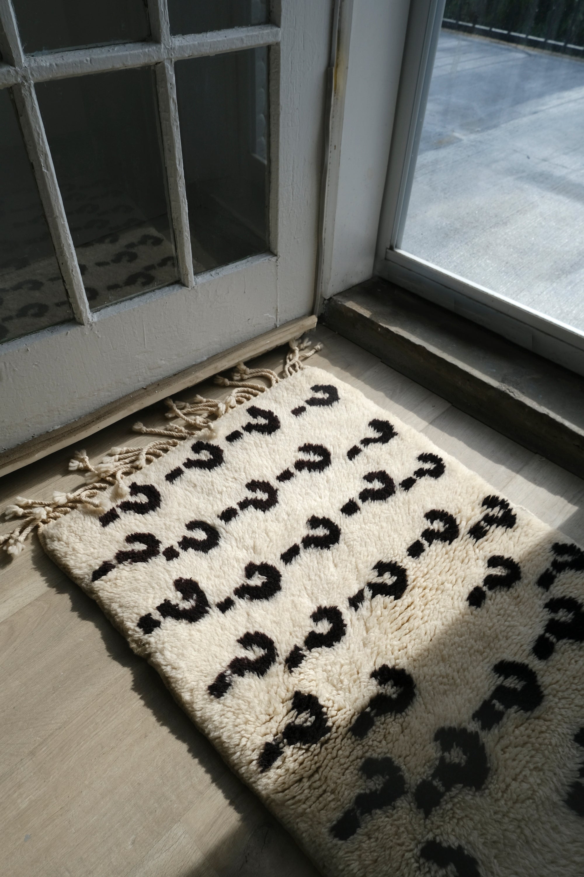 Experience the ultimate comfort with our 'Ivory Enigma Rug: Super Soft Playful Question Marks in Black Yarn.' Crafted for coziness, this rug showcases a delightful pattern of playful question marks in black yarn on an ivory background. Its irresistibly fuzzy texture adds a touch of luxury to any space, making it a perfect addition to your home. Elevate your décor with this charming blend of softness and whimsy.